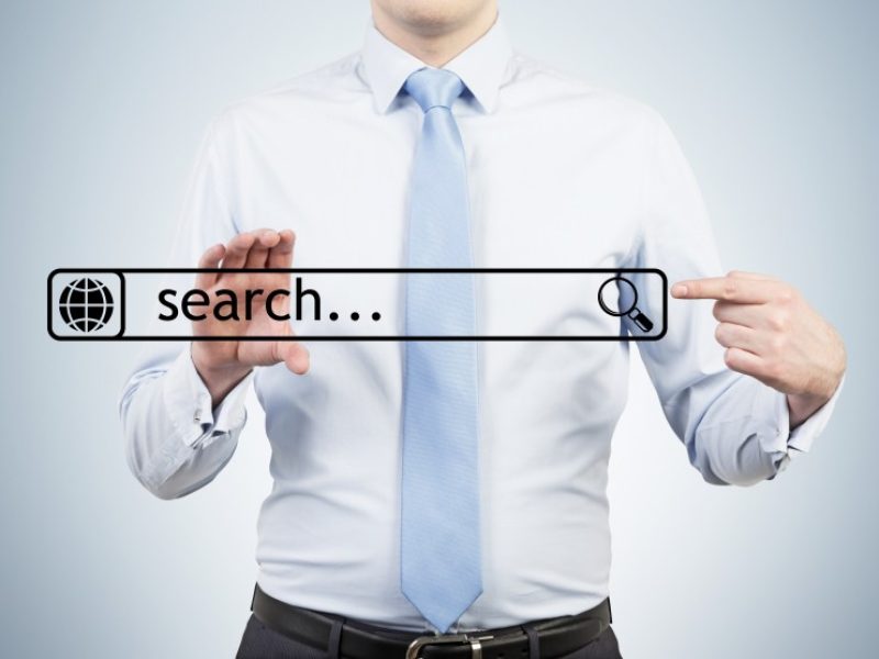 Businessman is holding the internet search bar in their hands.